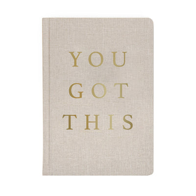 Write down all of your goals and dreams in our You Got This tan and gold fabric journal! With this chic, stylish, easy to write on notebook, there's no better place to jot down motivational notes, inspirational quotes, lists, and all of your great ideas.  DETAILS:  Size: 8.1 x 5.6 x 0.6” Design: You Got This Tan Fabric Journal with Gold Foil Details 100gsm Uncoated Lined Paper Ribbon Bookmark in Gold 100 Pages Front and Back (200 Total) Designed in the USA  