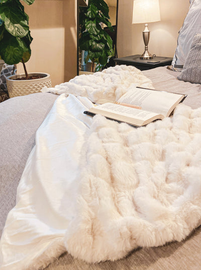 Crafted of a soft plush sculpted faux rabbit fur. So silky to the touch and cozy to snuggle into to create the ultimate comfort zone.  50x60 Reverses to soft fleece for extra coziness.  100% polyester faux rabbit fur  Machine washable 