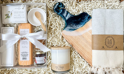 Experience the ultimate in comfort and luxury with our Cozy Home Oasis Gift Package . This exquisite collection features a Turkish hand towel, perfect for adding a touch of elegance to any bathroom or kitchen. The small resin art cutting board adds a unique and artistic flair to your culinary creations. Set the mood with our 8oz hand poured soy candle, gently infusing your space with a soothing and refreshing fragrance.  Enhance your snacking experience with our mini charcuterie kit
