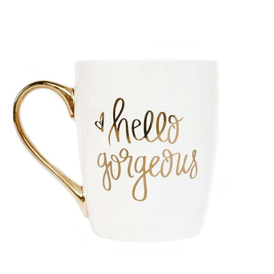 • 16oz Fine Bone China  • Size: 4 3/4 x 3 7/8" (5 5/8" w/handle)  • Hand Lettered Design: Hello Gorgeous  • Design On Both Sides of Mug  • White with Real Gold Embellished Handle and Design  • Designed in the USA, Imported