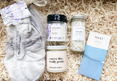 Treat your feet (and body) to a relaxing at-home spa day!  This set focuses on your tootsies with the luxe spa quality footies and lavender foot balm.  Indulge yourself by lighting the candle and taking a bath using the calm lavender bath salts, while snacking on quality organic sea sat chocolate. 