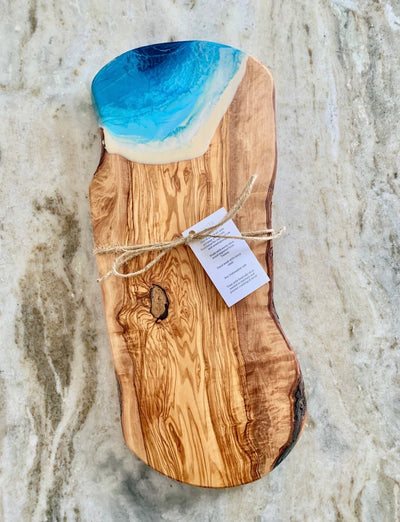 Gorgeous exotic olive wood imported from Italy in the 'Ocean' color.  This beautiful board is functional art at it's best.  It will surely make a statement in your home.   All sizes and shapes vary. 13"- 14". 