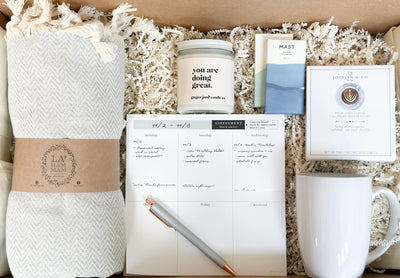 Send love, support and motivation with this encouraging gift set.  It was curated with the college student or young professional in mind, but anyone who needs some encouragement will love this gift set.  It includes a Turkish throw blanket, "you are doing great" soy candle, weekly open-date desk planner, standard blank ink pen, coffee mug, pour over coffee and mini chocolates.  A mix of comfort + practical items that they will be sure to love. 