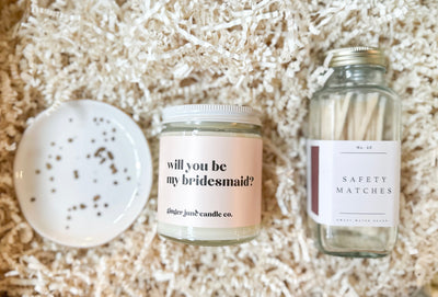 Make the most of your proposal and send her this “will you be my bridesmaid?” gift set. She will love the gorgeous small white and gold speckled jewelry dish, non-toxic soy candle and stylish safety matches. 