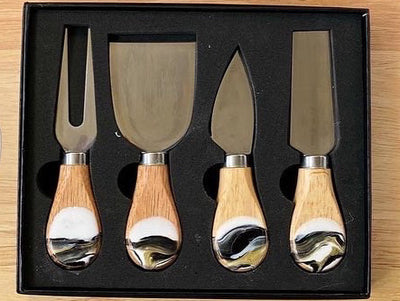 4 wood cheese utensils set in a beautiful black gift box. Each piece is one of a kind organically pour with black, white and gold dripped sides.