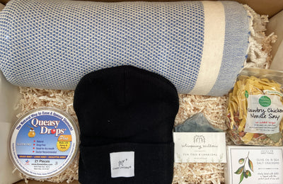 This comforting care package was curated with him in mind.  He will enjoy the blue fleece wrap blanket, a black beanie, tea tree & charcoal soap, chicken noodle soup and mini olive oil & sea salt crackers.  